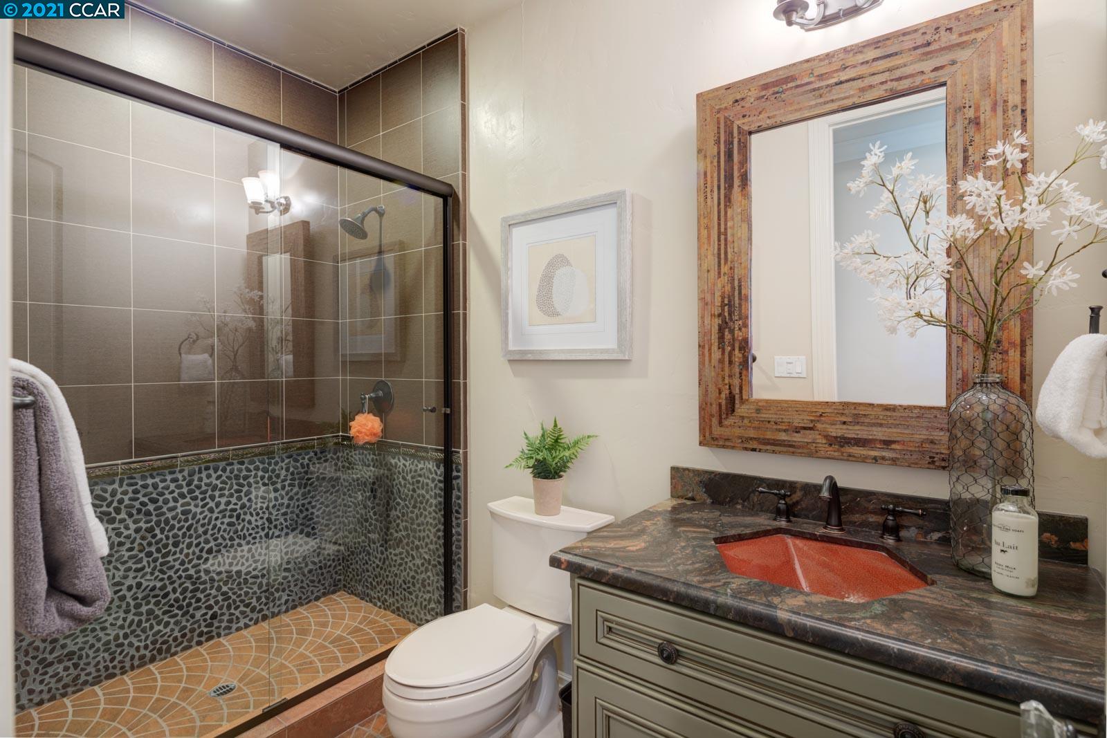 Undisclosed Address Diablo, CA 94526 - Photo 36 of 40 a bathroom with a granite countertop sink a toilet a mirror and shower