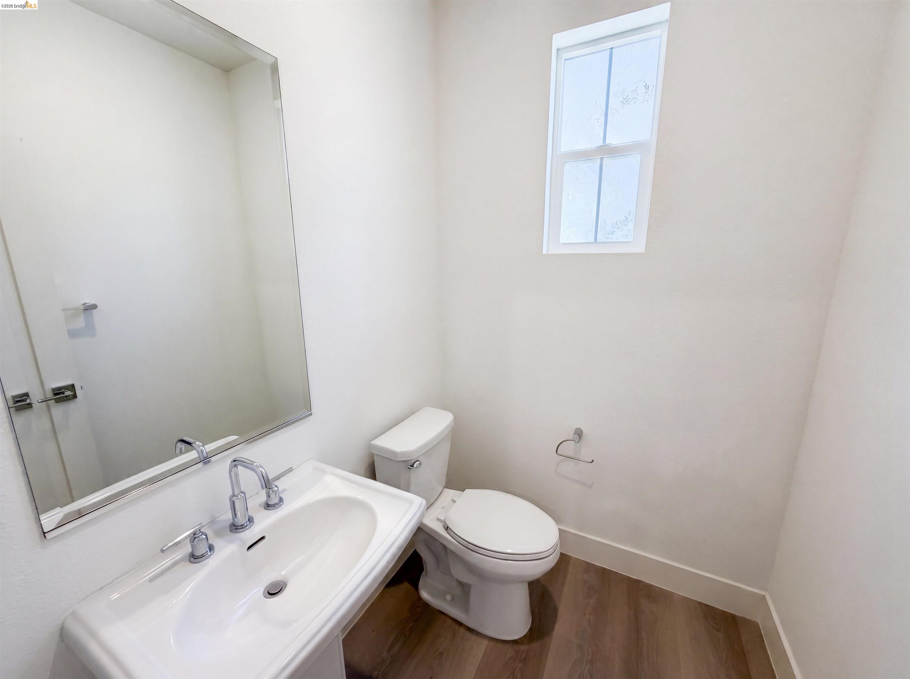 9034 Rudder Way Newark, CA 94560 - Photo 23 of 38 Pedestal sink with chrome fixtures and a rectangular mirror