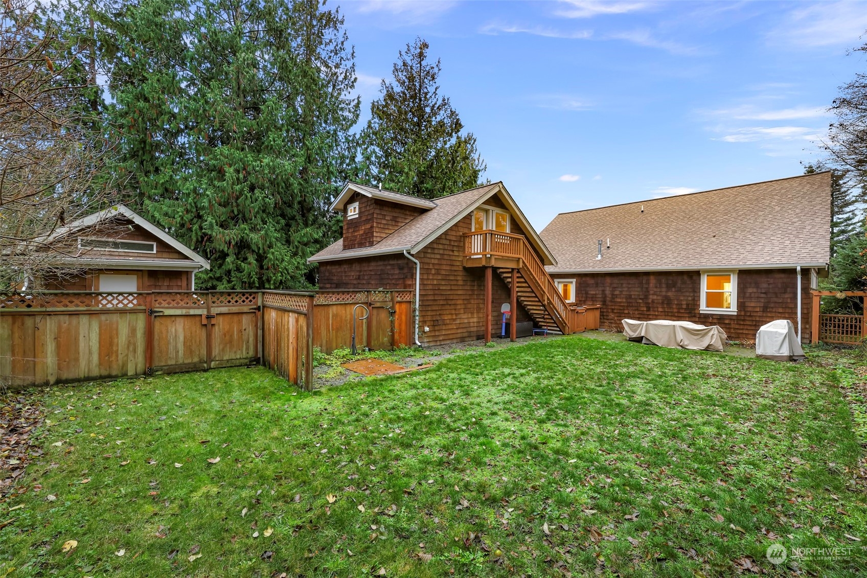 4384 Salmon Run Road Anacortes, WA 98221 - Photo 19 of 34 a view of a backyard with potted plants and large tree