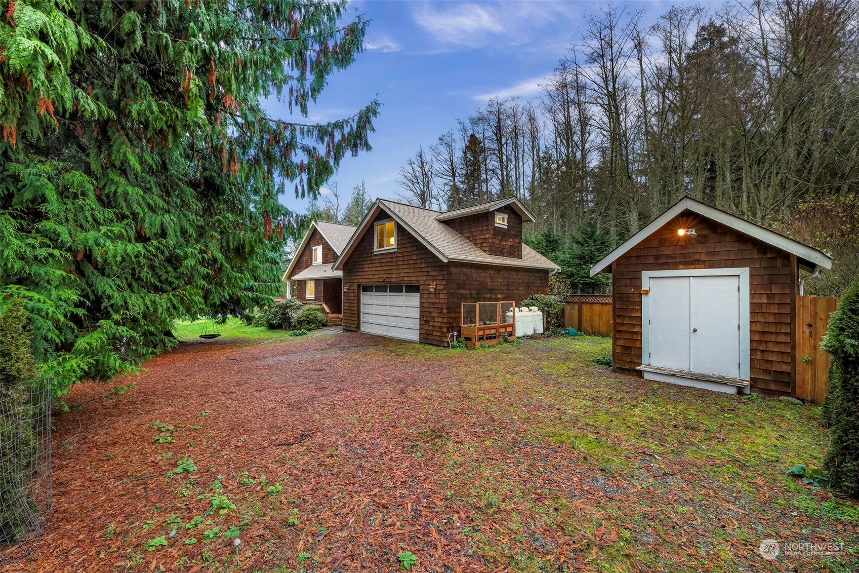 4384 Salmon Run Road Anacortes, WA 98221 - Photo 21 of 34 a front view of a house with a yard and garage