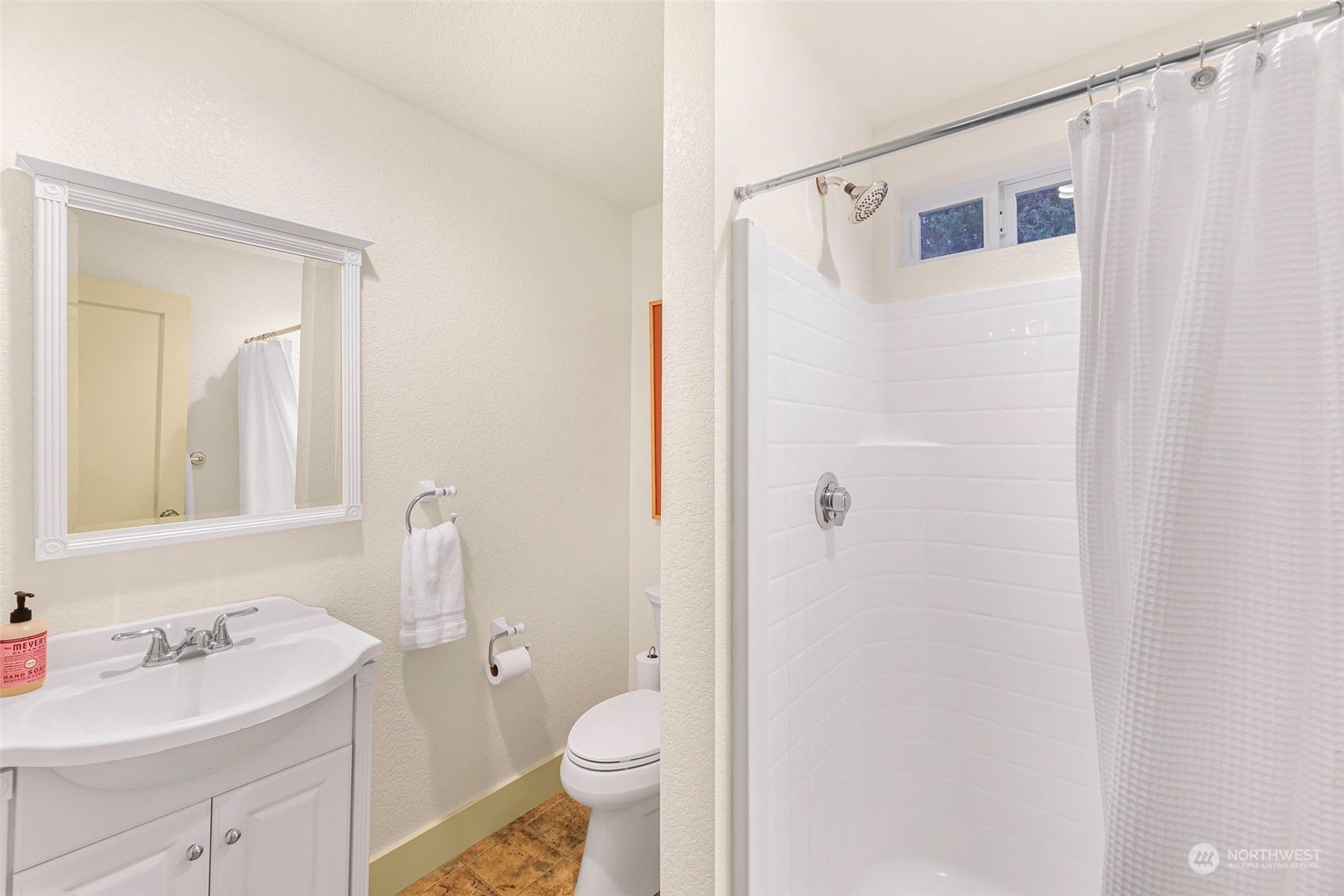 4384 Salmon Run Road Anacortes, WA 98221 - Photo 24 of 34 a bathroom with a sink a toilet and shower