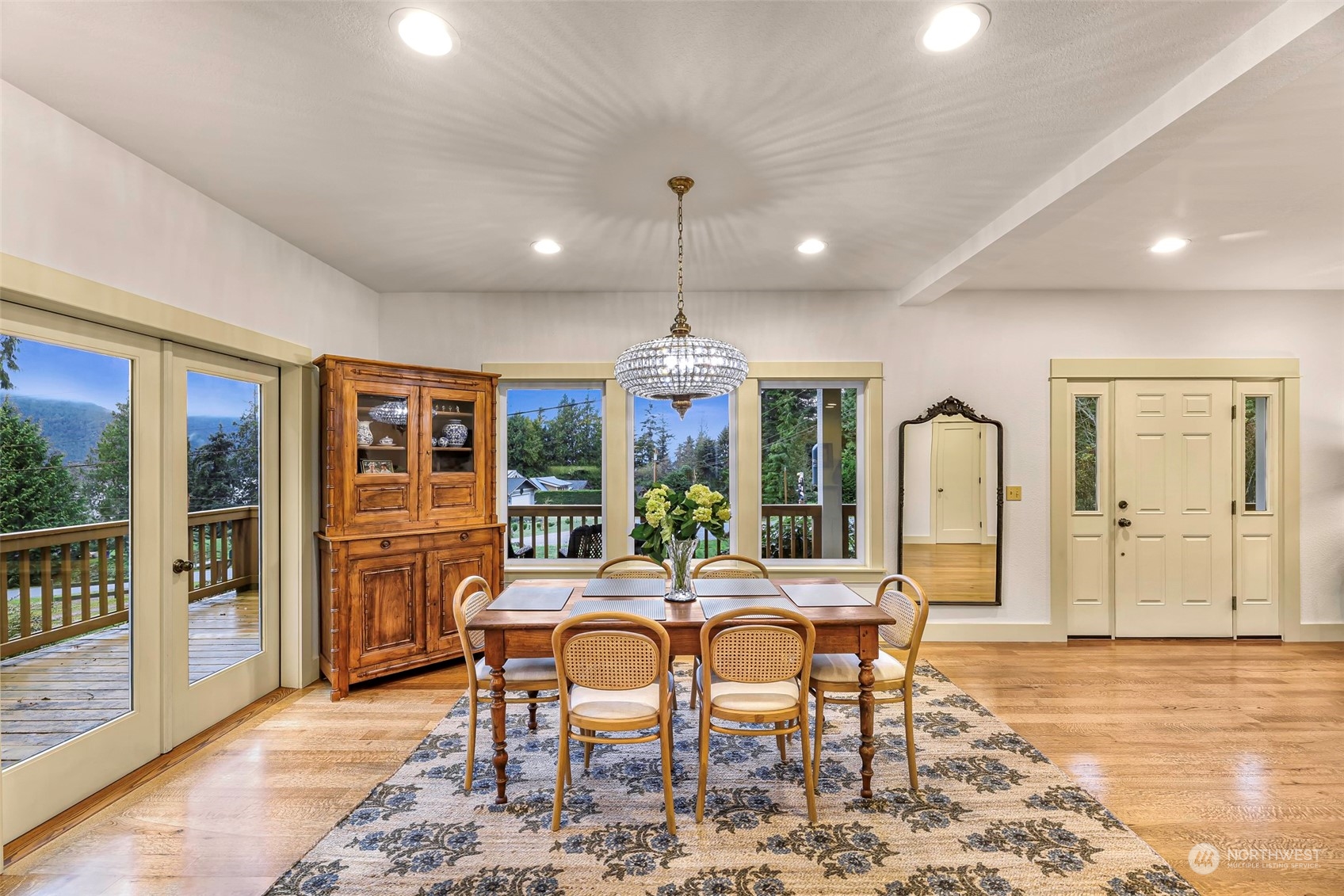 4384 Salmon Run Road Anacortes, WA 98221 - Photo 4 of 34 a dining room with furniture a chandelier and wooden floor