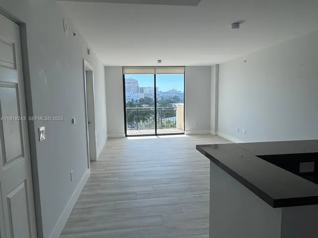 a kitchen with granite countertop stainless steel appliances and wooden cabinets