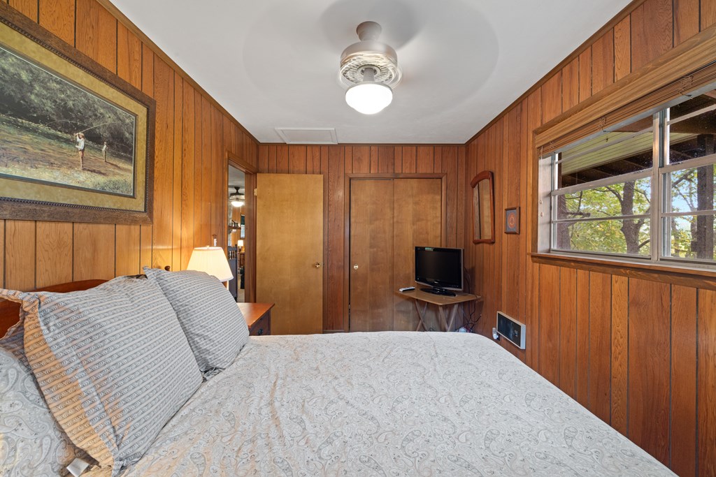 283 River Bend Lane Blue Ridge, GA 30513 - Photo 14 of 29 a bedroom with a bed and wooden floor