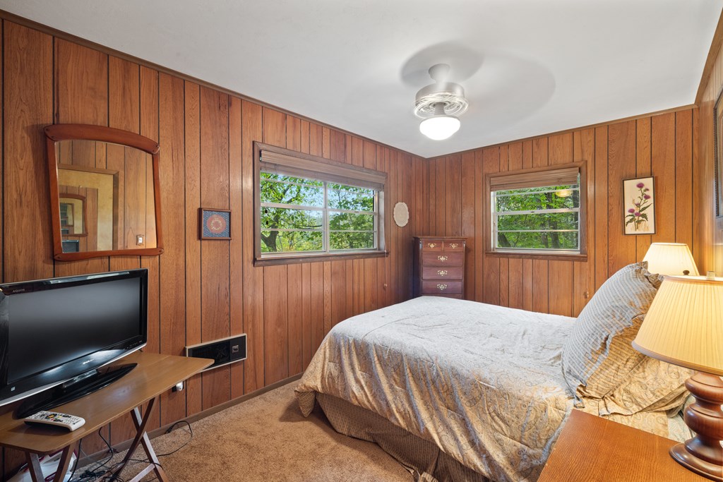 283 River Bend Lane Blue Ridge, GA 30513 - Photo 15 of 29 a bedroom with a bed tv and a window