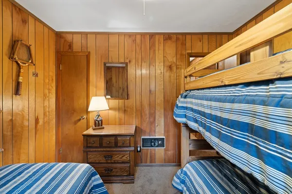 a view of a bedroom with closet and mirror