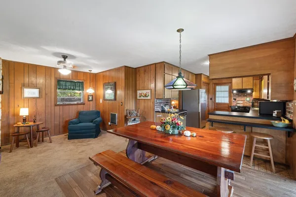 a view of a dining room with furniture window and wooden floor