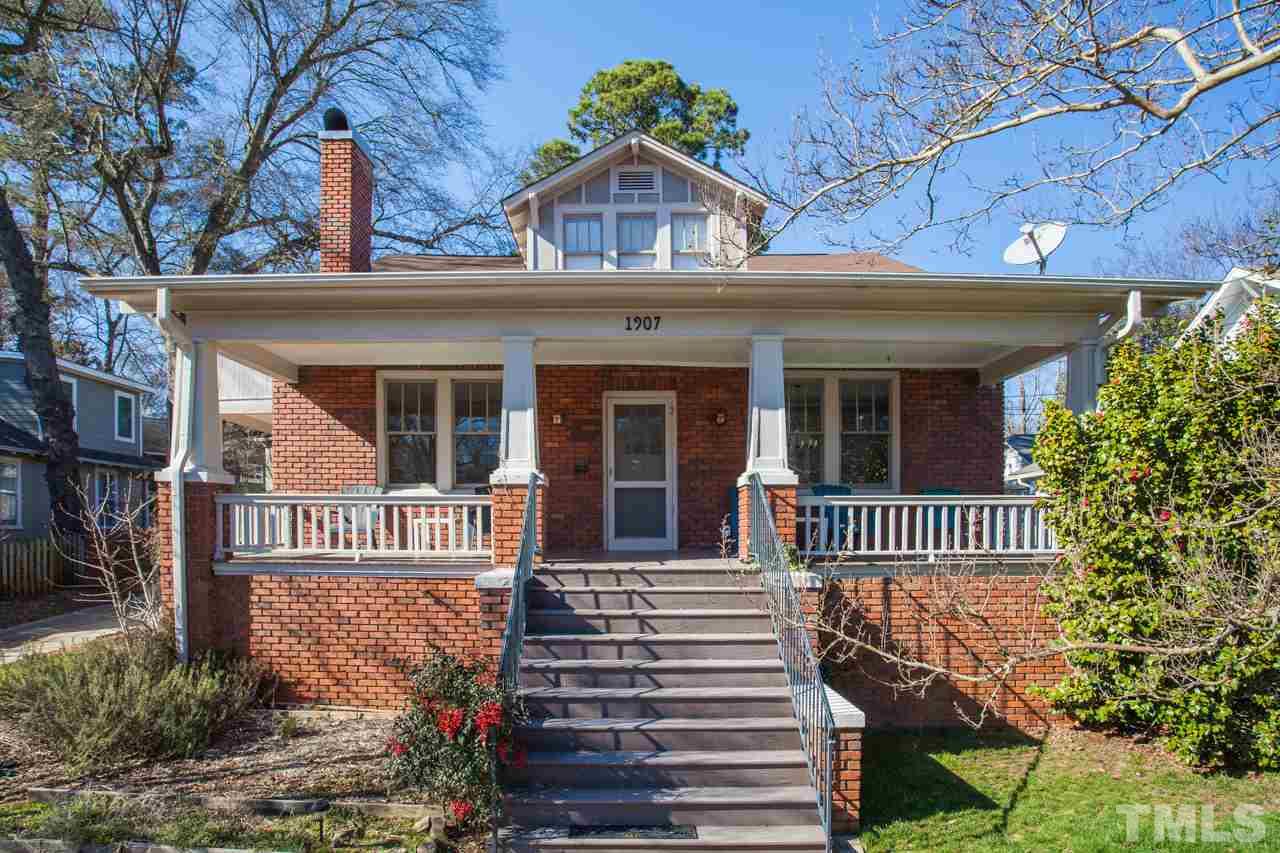1907 Alexander Road Raleigh, NC 27608 - Photo 1 of 29 a view of a house with a small yard and wooden fence