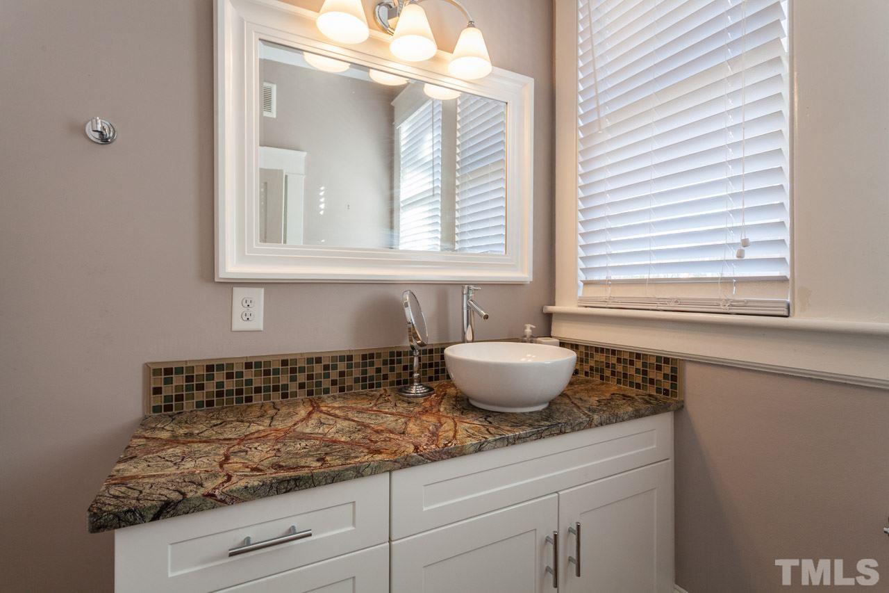 1907 Alexander Road Raleigh, NC 27608 - Photo 17 of 29 a bathroom with a granite countertop sink and a window