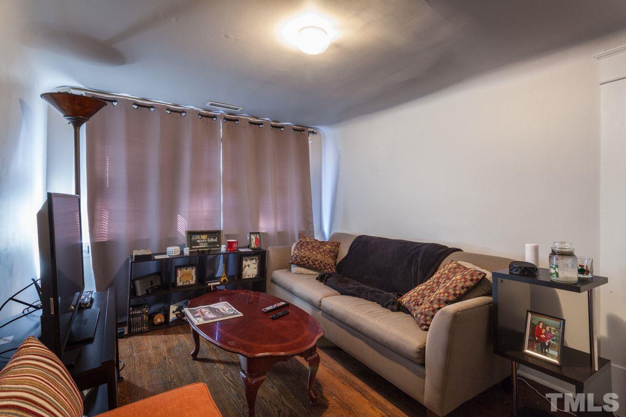 1907 Alexander Road Raleigh, NC 27608 - Photo 23 of 29 a living room with furniture and a lamp