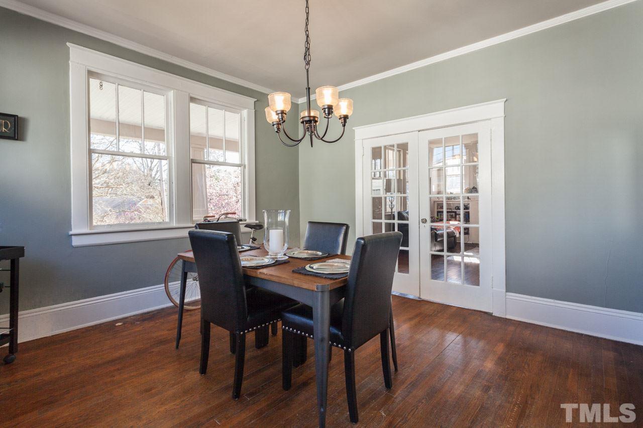 1907 Alexander Road Raleigh, NC 27608 - Photo 5 of 29 a view of a dining room with furniture window and wooden floor
