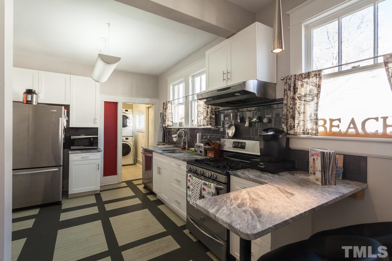 1907 Alexander Road Raleigh, NC 27608 - Photo 10 of 29 a kitchen with a refrigerator a stove a sink and a cabinets