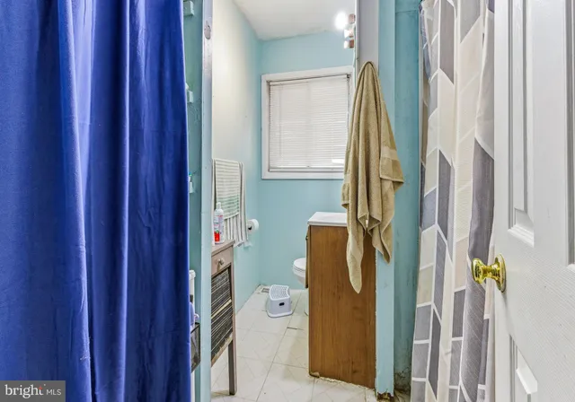 a bathroom with a sink a mirror and a window