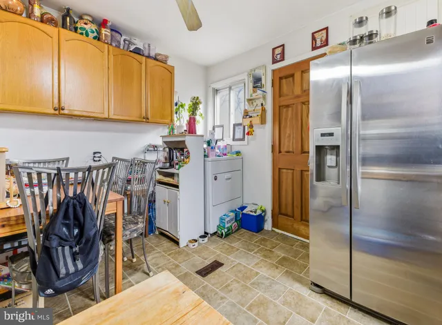 a kitchen with stainless steel appliances granite countertop a refrigerator and a stove