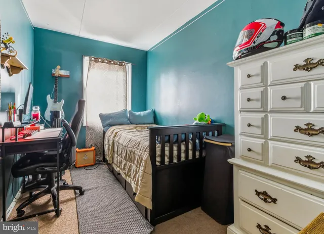 a bedroom with furniture and a book shelf