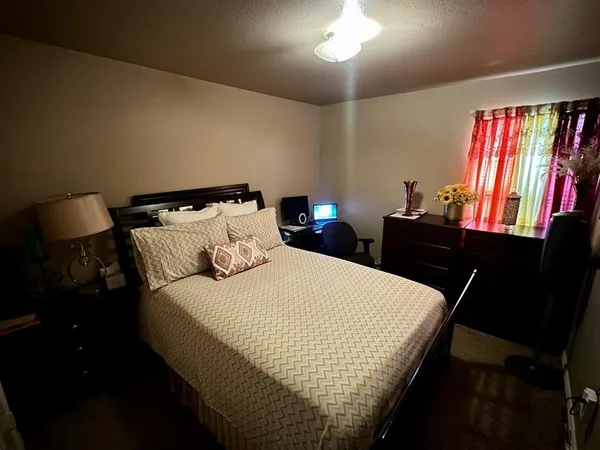 a bedroom with a bed and a television