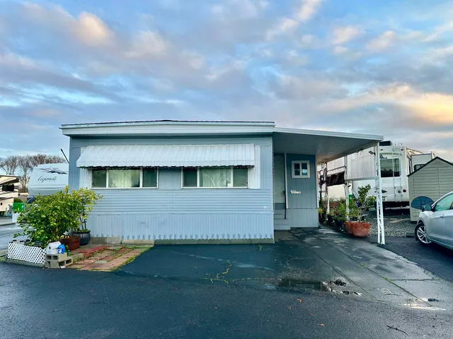 a kitchen with stainless steel appliances granite countertop a stove a microwave and a refrigerator