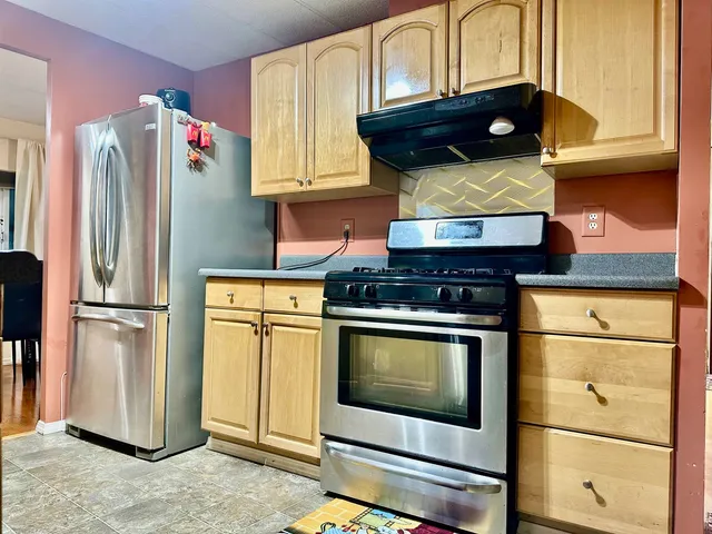 a kitchen with stainless steel appliances granite countertop a stove sink and cabinets