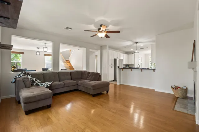 a living room with furniture and kitchen view