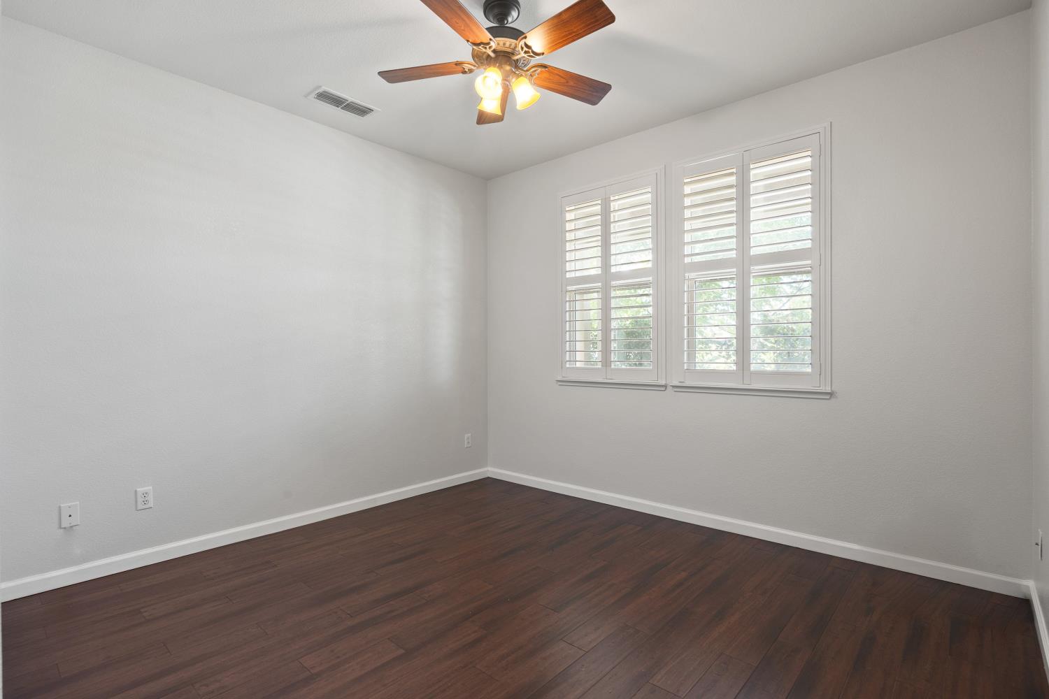 1325 Coby Lane Orland, CA 95963 - Photo 14 of 36 a view of an empty room with wooden floor and a window