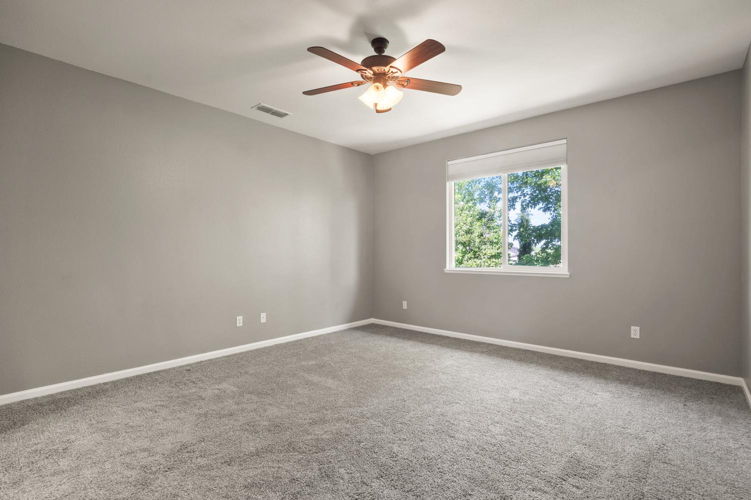 1325 Coby Lane Orland, CA 95963 - Photo 16 of 36 an empty room with windows and chandelier fan