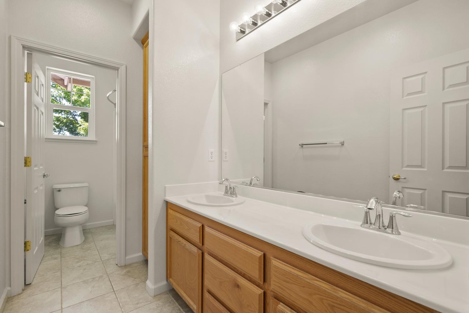 1325 Coby Lane Orland, CA 95963 - Photo 20 of 36 a bathroom with a granite countertop sink a toilet and a mirror