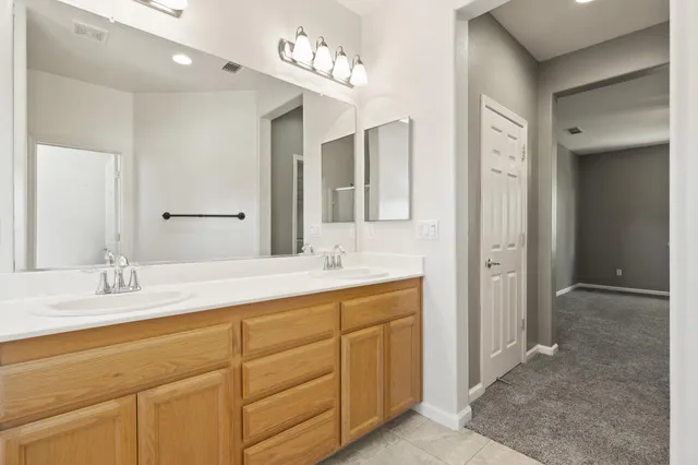 a bathroom with a sink double vanity and a mirror