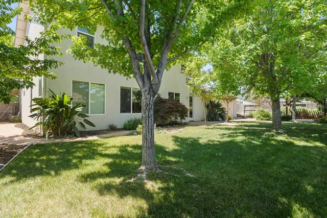 a backyard of a house with table and chairs