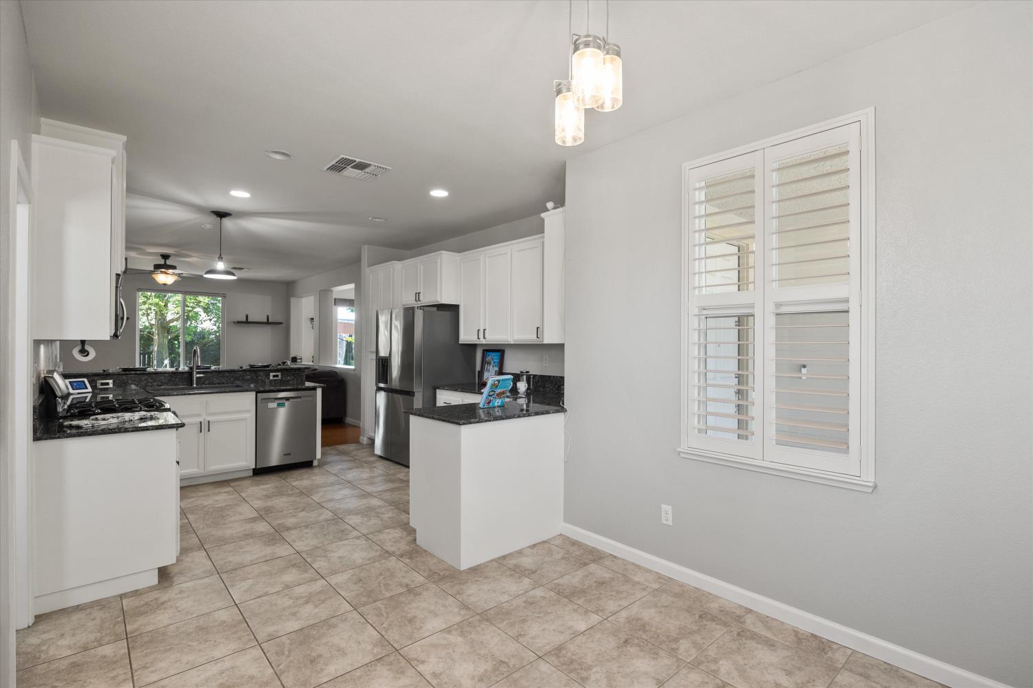 1325 Coby Lane Orland, CA 95963 - Photo 34 of 36 a kitchen with kitchen island white cabinets and stainless steel appliances