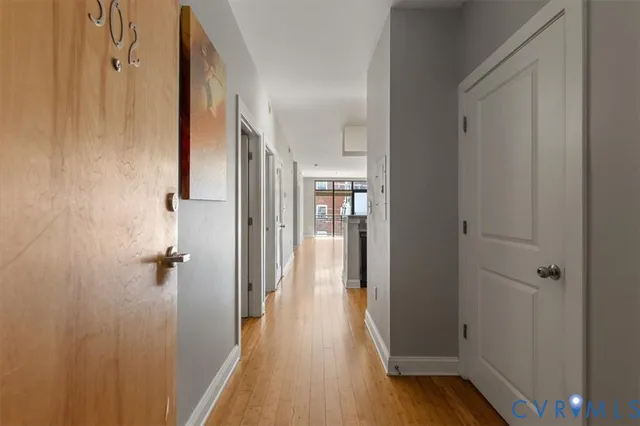 a view of a hallway with wooden floor and staircase