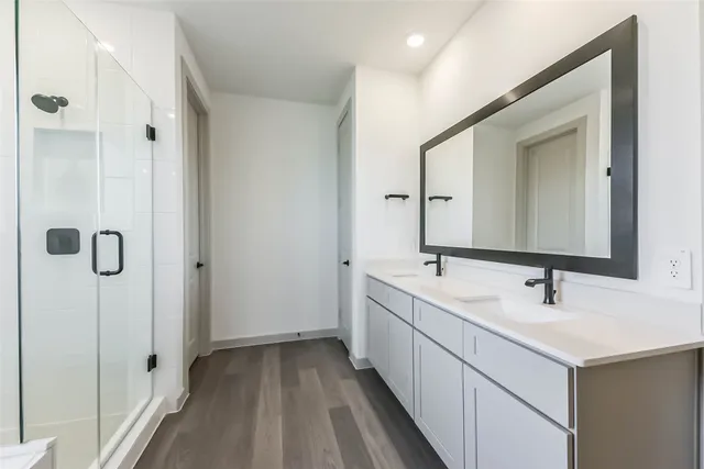a bathroom with a double vanity sink mirror and