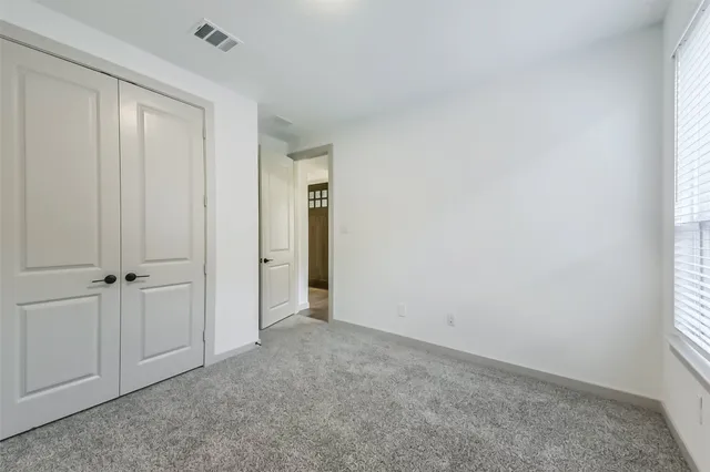 a view of an empty room and closet area