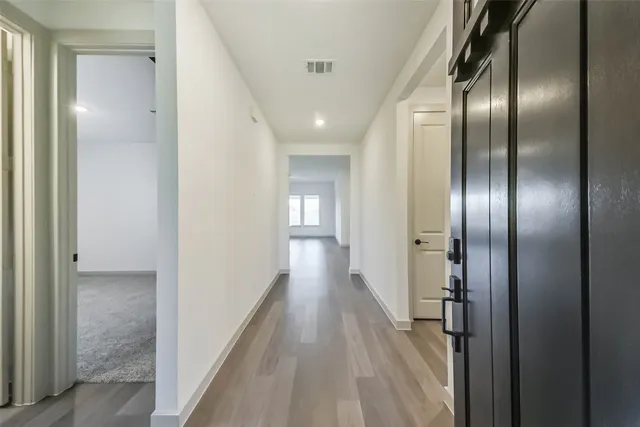 a view of hallway with wooden floor