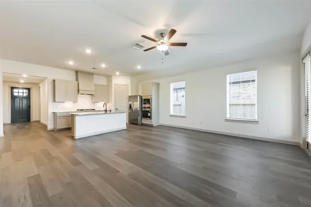 a view of an empty room with window and cabinet