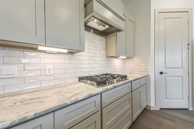 a kitchen with granite countertop cabinets and stove