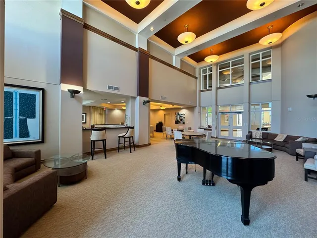 a living room with furniture a fireplace and large windows