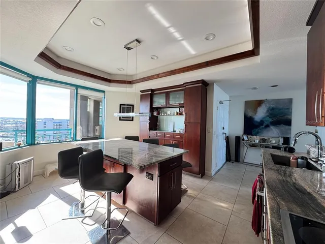 a living room with furniture a flat screen tv and a large window