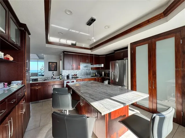 a kitchen with kitchen island a stove and a refrigerator
