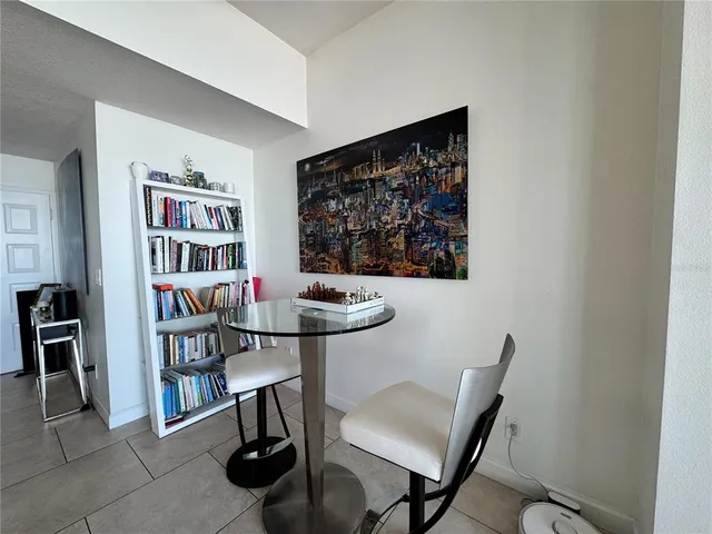 a view of a livingroom with furniture and bookshelf