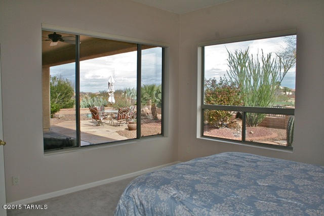 1729 East Redstart Road Green Valley, AZ 85614 - Photo 24 of 39 a view of a room that has a bed and a window