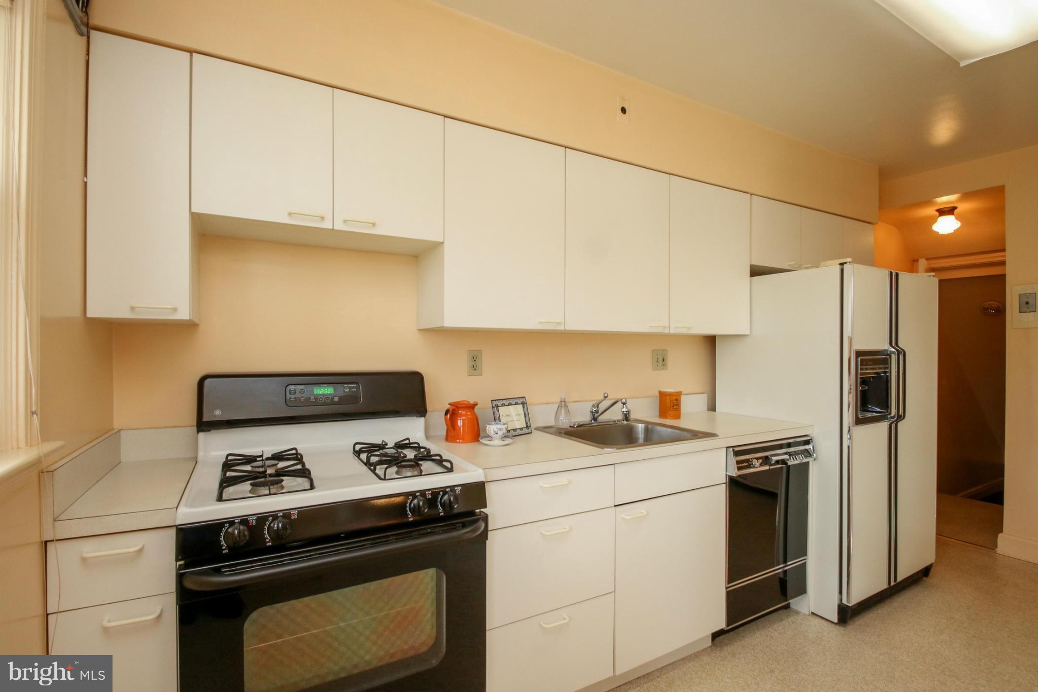 3919 Fallstaff Road Baltimore, MD 21215 - Photo 8 of 15 a kitchen with a stove and a refrigerator