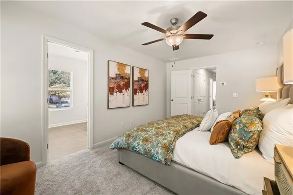 a bedroom with a large bed and a window