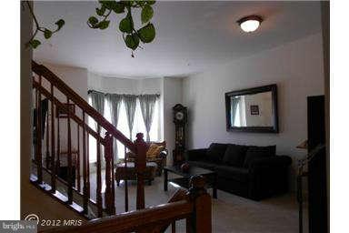 3025 Raking Leaf Drive Abingdon, MD 21009 - Photo 13 of 26 a living room with lots of frames and flower vase