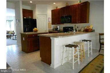 3025 Raking Leaf Drive Abingdon, MD 21009 - Photo 9 of 26 a kitchen with a sink a stove and cabinets