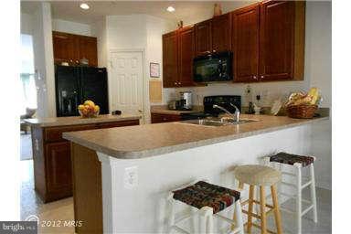 3025 Raking Leaf Drive Abingdon, MD 21009 - Photo 10 of 26 a kitchen with a sink a microwave and cabinets