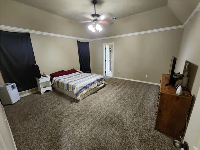 a bedroom with a bed and a ceiling fan
