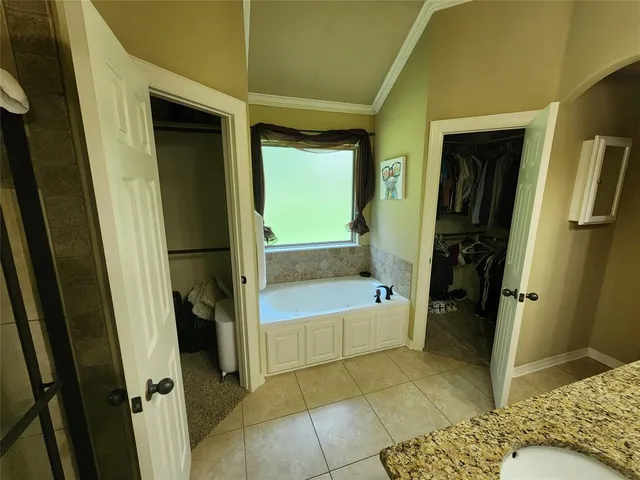 a bathroom with a tub and a sink