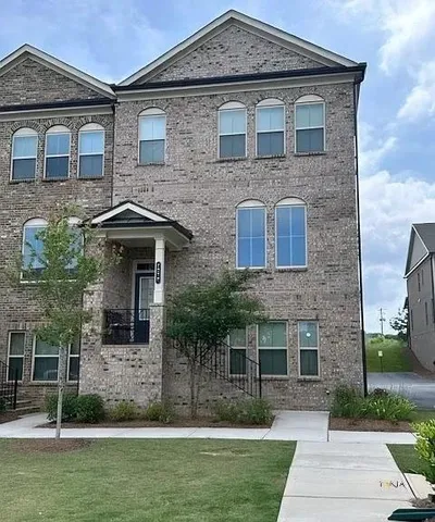 a front view of a house with garden