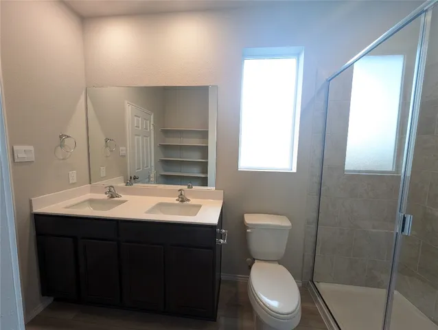 a bathroom with a toilet sink and mirror