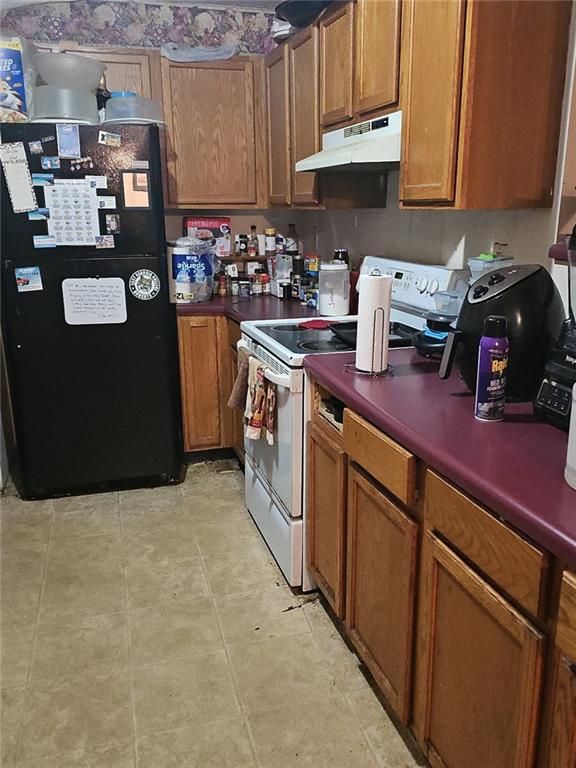 207 Fowler Street Swainsboro, GA 30401 - Photo 7 of 9 a kitchen with stainless steel appliances granite countertop a refrigerator a stove and a sink